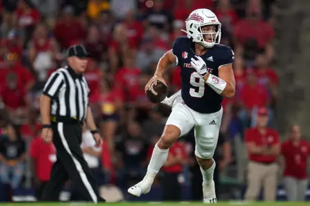 Sep 11, 2021; Fresno, California, USA; Fresno State Bulldogs quarterback Jake Haener (9) rolls out to throw a pass against the Cal Poly Mustangs in the first quarter.