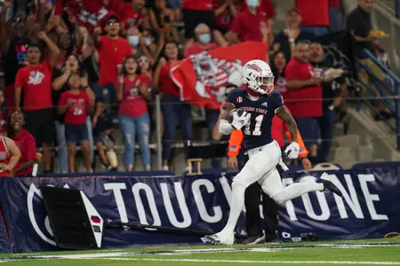 Sep 11, 2021; Fresno, California, USA; Fresno State Bulldogs wide receiver Josh Kelly (11) scores a touchdown against the Cal Poly Mustangs in the second quarter.
