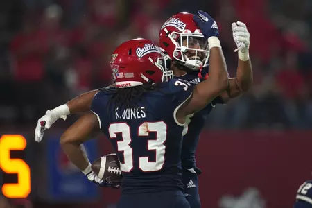 Sep 24, 2021; Fresno, California, USA; Fresno State Bulldogs defensive back Justin Houston (13) and defensive end Kwami Jones (33) celebrate after the Bulldogs recovered a fumble against the UNLV Rebels in the fourth quarter.