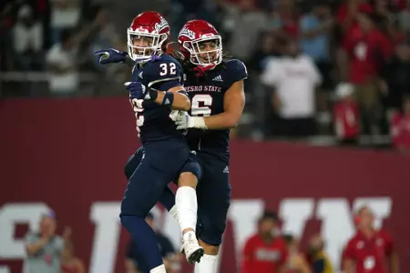 Sep 24, 2021; Fresno, California, USA; Fresno State Bulldogs defensive back Evan Williams (32) and linebacker Levelle Bailey (6) celebrate after the Bulldogs recovered a fumble against the UNLV Rebels in the fourth quarter.
