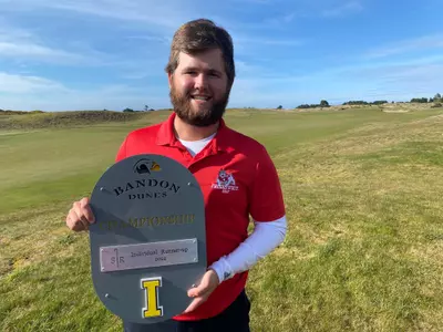 Matthew Sutherland holding second place trophy at Bandon Dunes Invitational