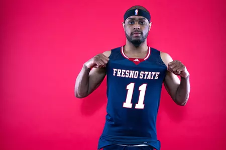 Jordan Brinson, blue uniform, red background, signee