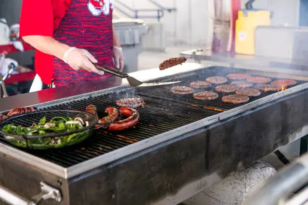 Dog Pound Grill, hamburger flipping, veggies, sausages