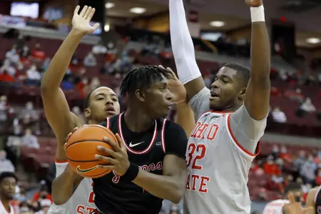 Jan 18, 2022; Columbus, Ohio, USA; IUPUI Jaguars forward Chuks Isitua (23) guarded by Ohio State Buckeyes forward E.J. Liddell (32) and forward Zed Key (23) during the first half at Value City Arena. Mandatory Credit: Joseph Maiorana-USA TODAY Sports