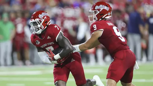 Fresno State quarterback Jake Haener hands the ball off to running back Jordan Mims