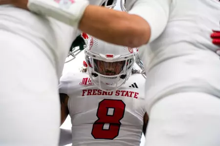 Tuasivi Nomura in captain's huddle at New Mexico