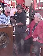 Don Fightmaster receives a symbol of thanks from AD Tom Jurich, with Owsley Brown Frazier looking on.