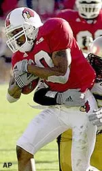 Louisville wide receiver Arnold Jackson hauls in a pass despite the defense of Army's David McCracken.