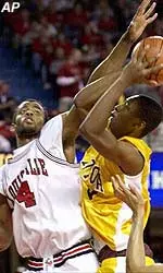 Louisville's Hajj Turner blocks a Loyola shot during Monday's 86-70 win.
