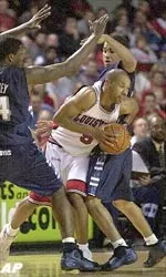 Louisville's Marques Maybin fights his way through the Georgetown defense.