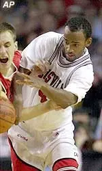 Louisville's Hajj Turner fights for a loose ball during first half action.