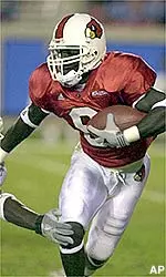 Louisville's Deion Branch breaks through the tackle of a Conneticut defender.