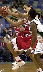 Louisville forward Luke Whitehead (24) drives to the basket while being blocked by Tulane guard Brandon Spann during the first half in New Orleans, Wednesday night.