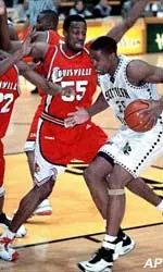 Louisville guard Reece Gaines and forward Joseph N'Sima block the path of Southern Mississippi forward Kilavorus Thompson.