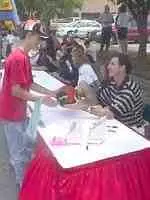 Coach Rick Pitino autographs a basketball for a fan