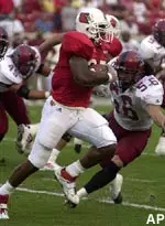 Tony Stallings runs past the defense of New Mexico State's Josh Watts during the first quarter Thursday.
