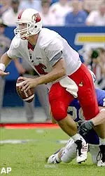 Louisville quarterback Dave Ragone tries to get out of the grasp of Kentucky defender Patrick Wiggins during first half Saturday, Sept. 1, 2001, in Lexington, Ky.