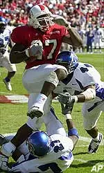 Tony Stallings attempts to run over the defense of Memphis' Shaka Hill and Derrick Ballard