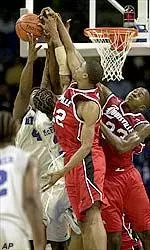 Reece Gaines and Erik Brown battle Memphis' Chris Massie and Scooter McFadgon for a rebound.