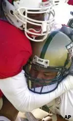 UAB quarterback Darrell Hackney is sacked by Louisville's Marcus Jones during the first half.