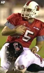 Quarterback Dave Ragone is pulled down by Cincinnati linebacker Tyjuan Hagler during the first half.