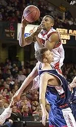 Reece Gaines goes up through the defense of South Alabama's Richard Law during the first half.