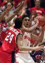 Indiana's Jared Jefferies is defended by Louisville's Luke Whitehead and Ellis Myles after grabbing a rebound in the first half, Saturday.