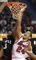 Luke Whitehead dunks the ball despite the defense of Temple's Alex Wesby during their second-round NIT game Tuesday.