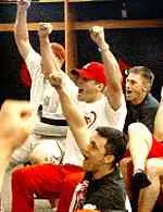 Members of the University of Louisville baseball team celebrate the first regional bid in the program's 93-year history.