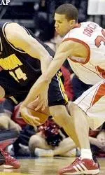 Francisco Garcia swipes the basketball from Iowa's Greg Brunner during the first half of the Wooden Tradition.