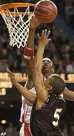 Otis George blocks the shot of VMI's Fred Robinson during first half action Tuesday at Freedom Hall.