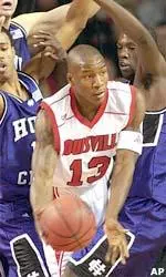 Alhaji Mohammed looks for a teammate as he encounters a bevy of Holy Cross defenders.