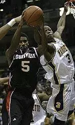 Taquan Dean left pulls down a rebound against Marquette's Dwyane Wade in the second half.