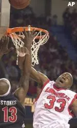 Cincinnati's Leonard Stokes has his shot blocked by Erik Brown during the first half of their game Wednesday.
