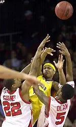 Reece Gaines and Taquan Dean trap East Carolina's Belton Rivers during the first half.