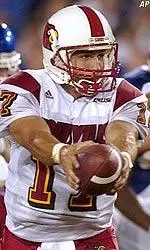 Quarterback Stefan LeFors hands the ball off during the first half.