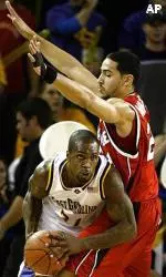 East Carolina's Derrick Wiley tries to pass the ball around Luke Whitehead during the first half.