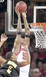 Otis George goes high above the rim to lay in a shot over Southern Mississippi's Dante Stiggers.
