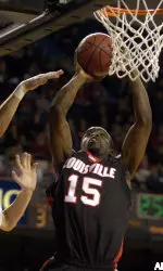 Perrin Johnson gets a shot off past the defense of Austin Peay's Tomas Janusauskas during the championship game of the Billy Minardi Classic Wednesday in Freedom Hall.