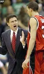 Coach Rick Pitino relays instructions to Francisco Garcia in the first half.
