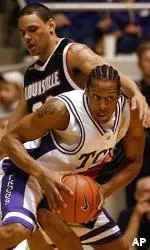TCU's Aaron Curtis drives past Louisville's Nate Daniels in the first half.
