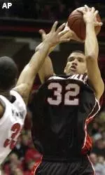 Francisco Garcia shoots in front of Cincinnati's Armein Kirkland during the first half.
