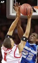 Kendall Dartez is fouled by Memphis' Anthony Rice as he flies to the basket.