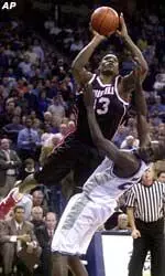 Louisville's Alhaji Mohammed drives to the basket over Memphis' Anthony Rice during the second half Wednesday.
