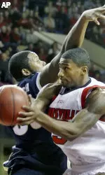 Louisville's Taquan Dean, right, goes to the basket past Akron's Matt Futch, to score two of his game-high 22 points at Freedom Hall in Louisville, Ky., Saturday, Dec. 10, 2005. Dean lead five Louisville players in double figures as the fifth-ranked Cardinals raced by Akron 111-85 (AP Photo/Garry Jones)