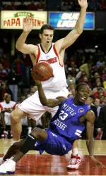 Middle Tennessee's Marcus Morrison looks for a teammate to pass to as he goes to the floor in front of David Padgett during the first half.
