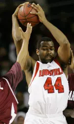Brian Johnson tries to keep the ball away from College of Charleston defenders Drew Hall and Josh Jackson during the first half.