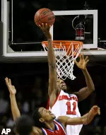 Detroit's Torvoris Baker can only watch as Louisville's Brandon Jenkins goes above the rim to drop in a shot during the first half of their basketball game Saturday, Dec. 24, 2005, in Louisville, Ky. (AP Photo/Ed Reinke)