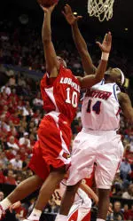 Edgar Sosa (10) takes the ball to the basket against Dayton's London Warren (14) (AP Photo)