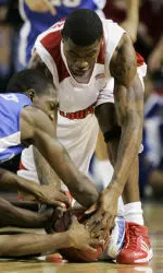 Louisville's Terrence Williams, right, and Kentucky players Joe Crawford, left, and Ramel Bradley go after a loose ball in the first half of a college basketball game, Saturday, Dec. 16, 2006, in Louisville, Ky. (AP Photo/Ed Reinke)